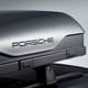 A close up photo of the Porsche logo on a roof top tent.